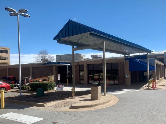 A large building with a blue awning over the entrance
