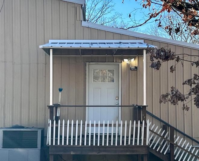 A house with a porch and stairs leading up to it