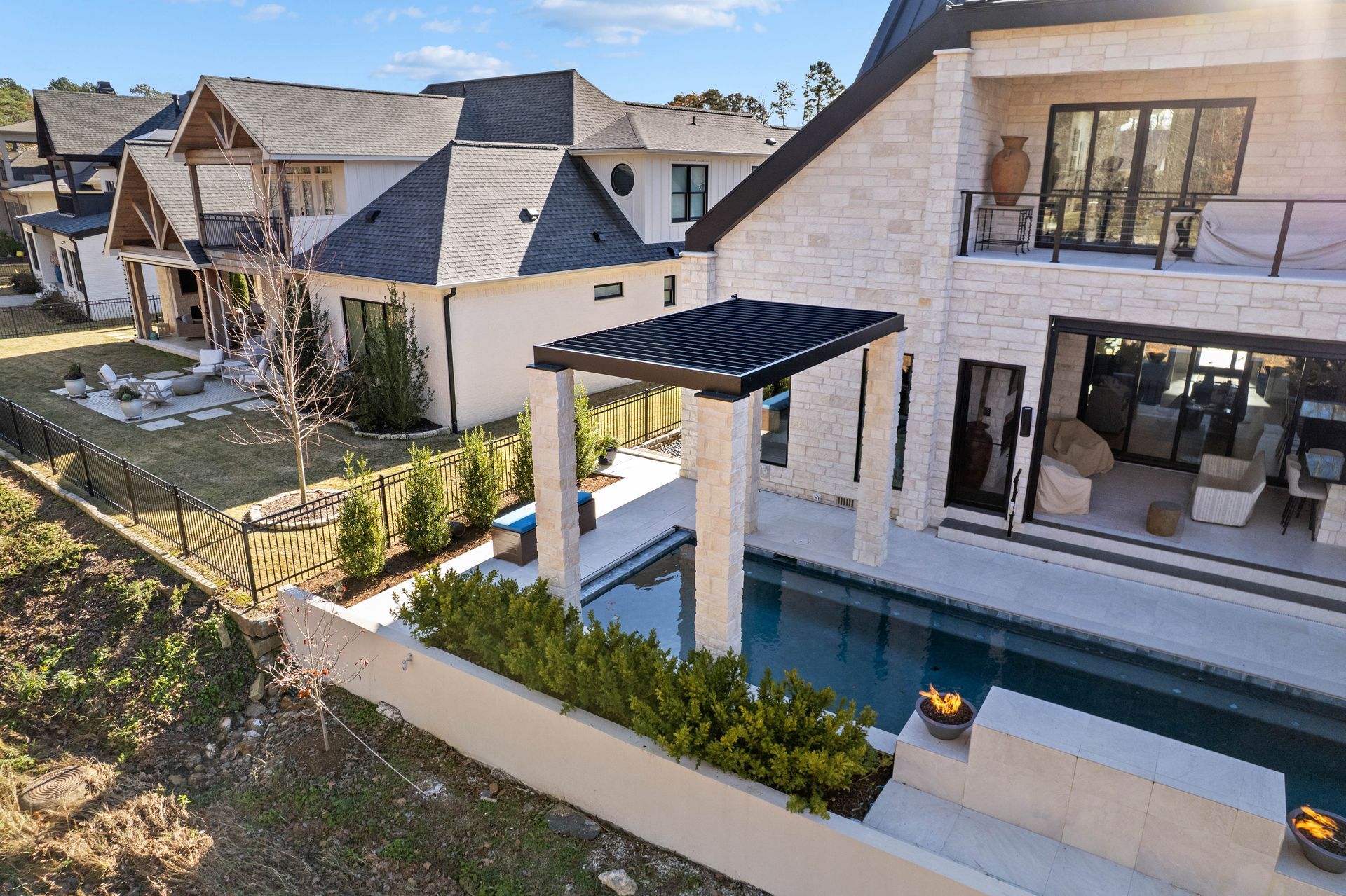 Modern house exterior with a covered patio, reflecting pool, and landscaped yard