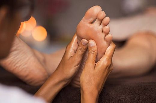 A person is getting a foot massage at a spa.