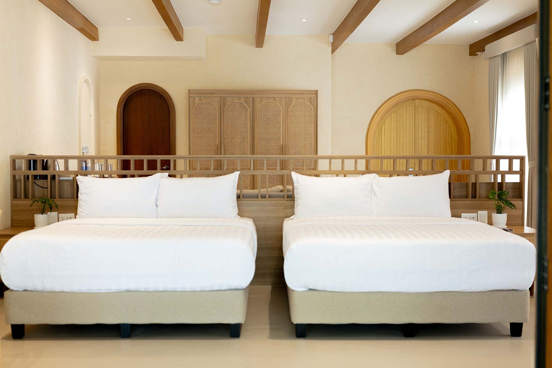 Beach Villa bedroom with two double beds and rattan wardrobe at Costa Solana Resort, Pagbilao, Quezon