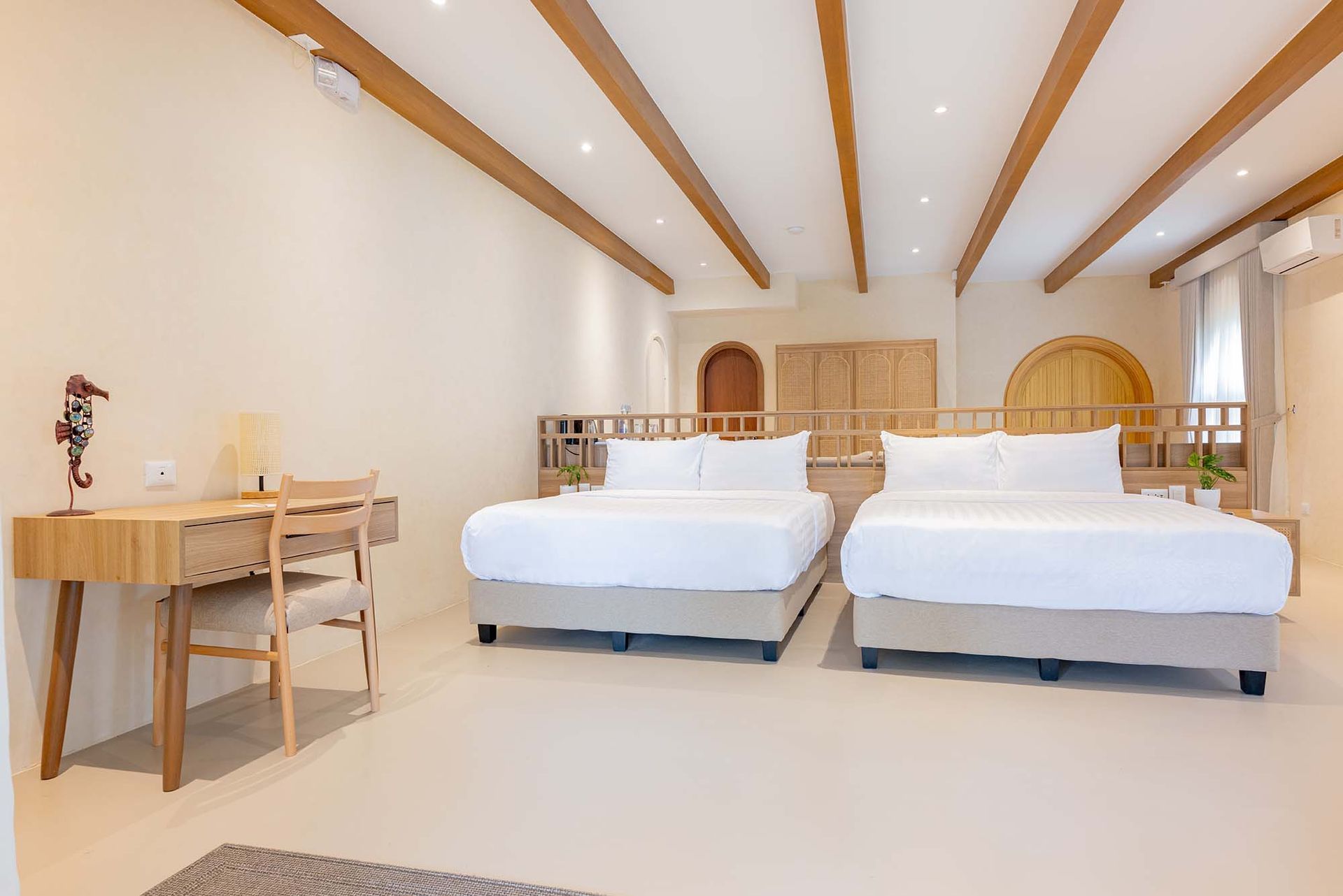 Beach Villa bedroom with wooden desk and natural light at Costa Solana Resort, Pagbilao, Quezon