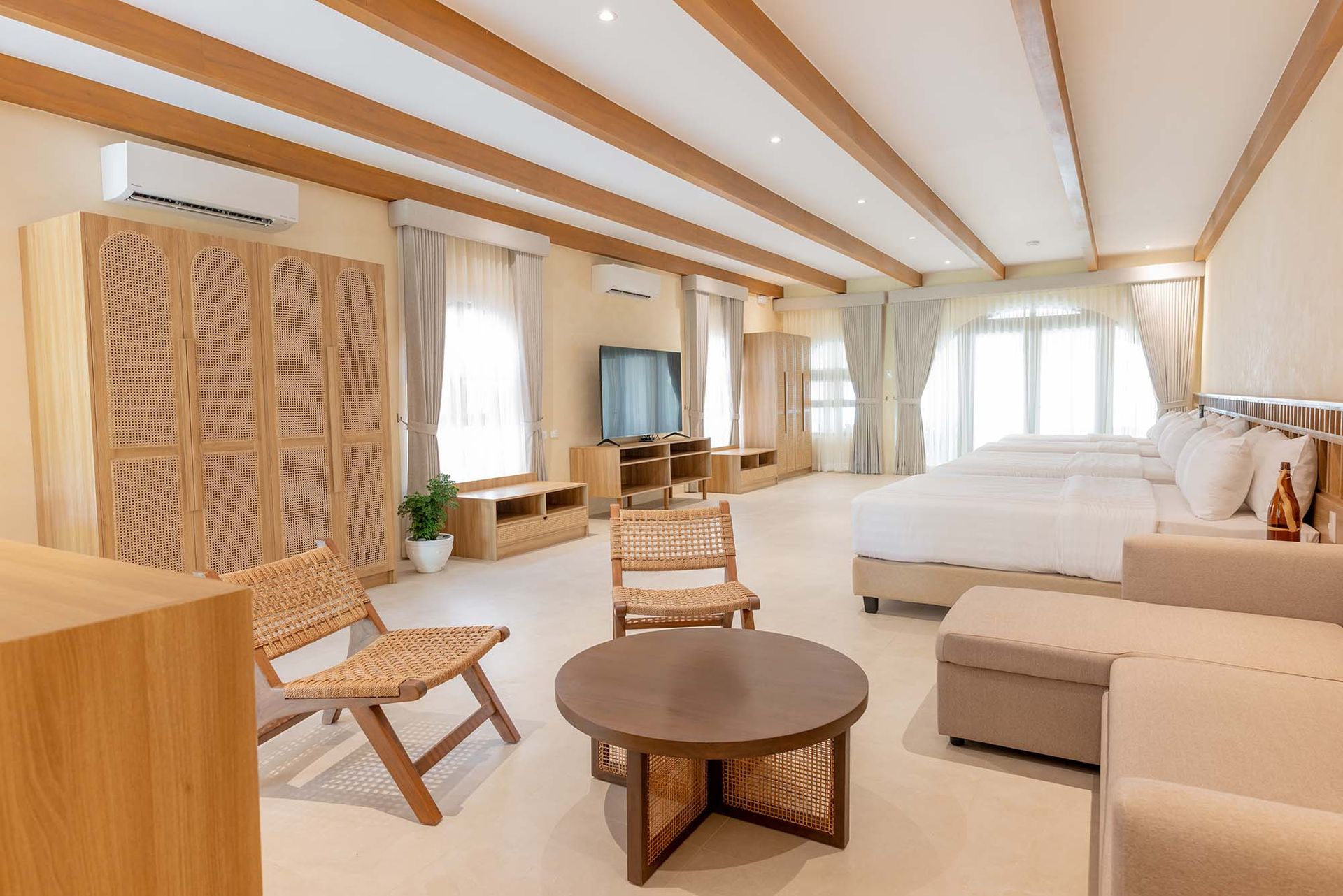 Family Beach Villa bedroom with wooden furniture and natural light at Costa Solana Resort, Pagbilao, Quezon