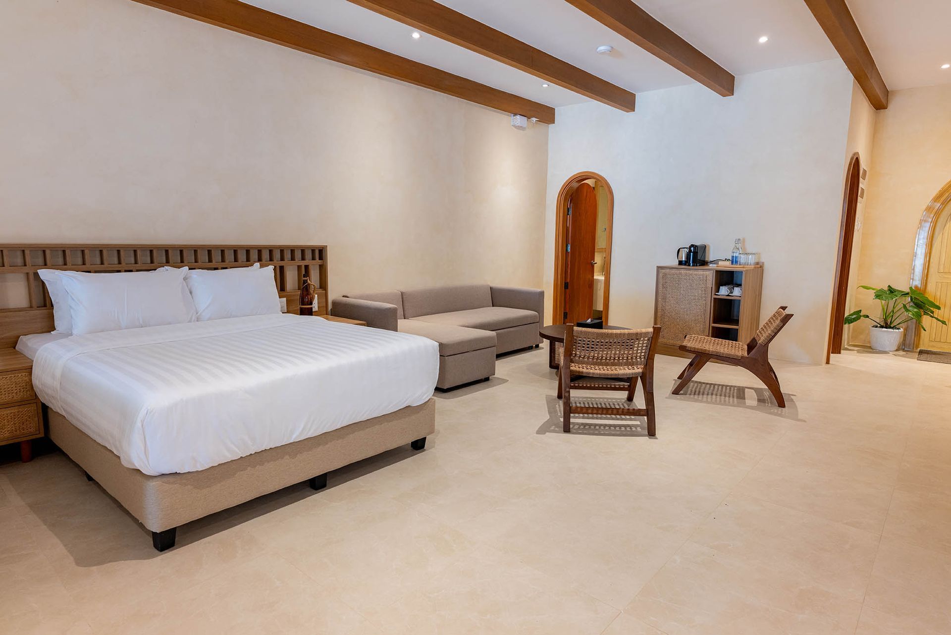 Family Beach Villa bedroom with double bed and wooden accents at Costa Solana Resort, Pagbilao, Quezon
