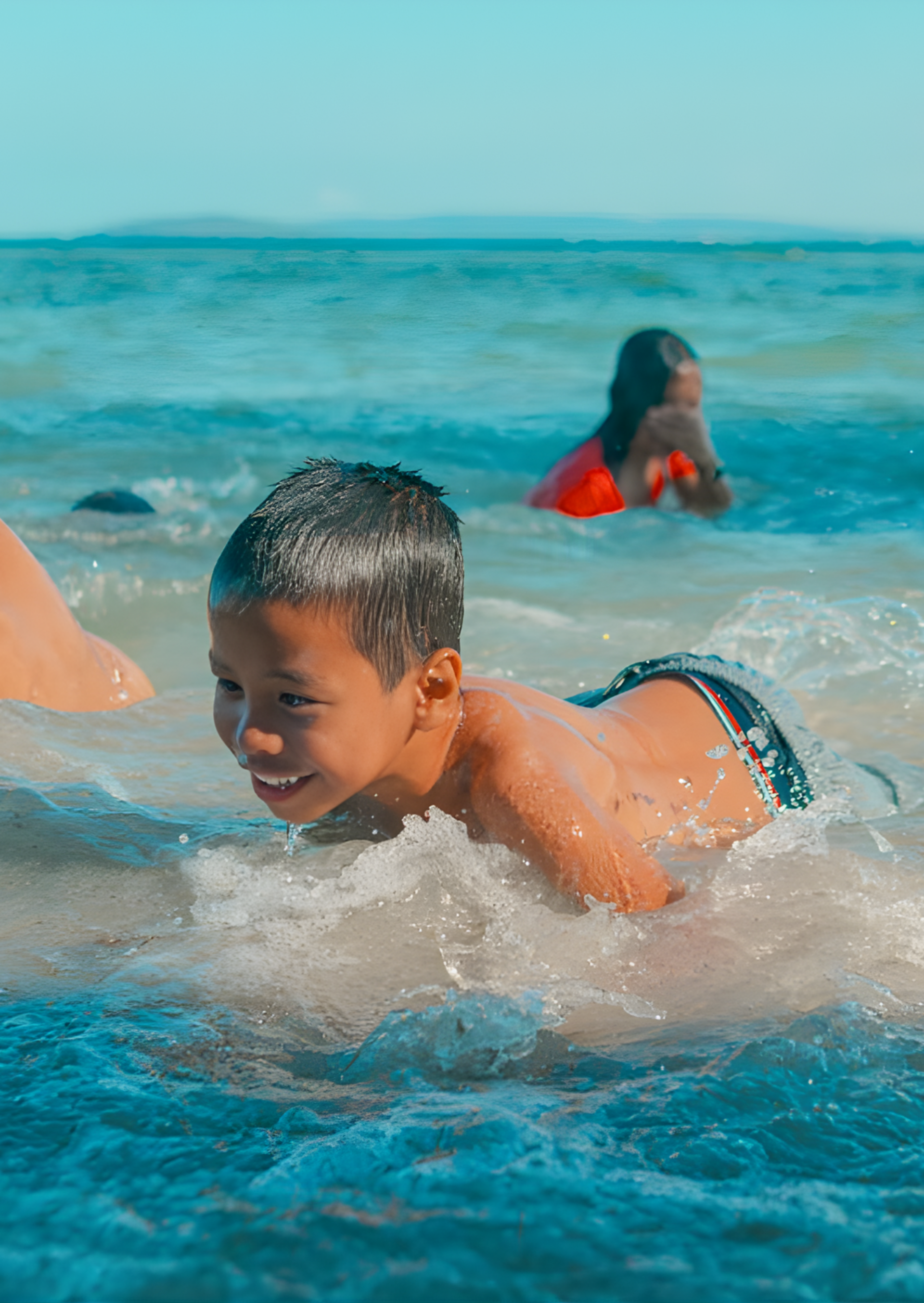 Happy boy playing in ocean waves at Costa Solana Pagbilao beach resort Quezon