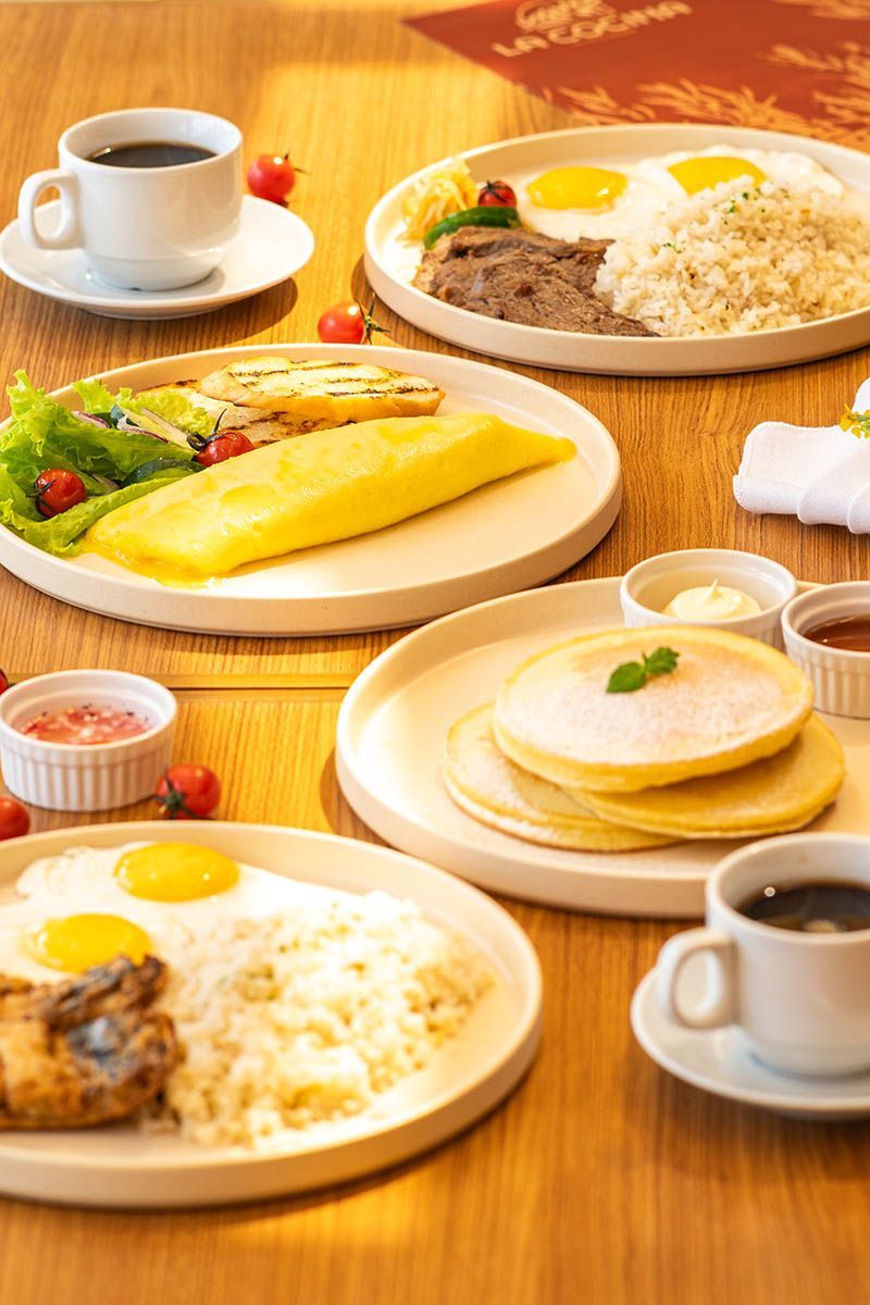 La Cocina breakfast spread with eggs, rice, pancakes, and coffee at Costa Solana