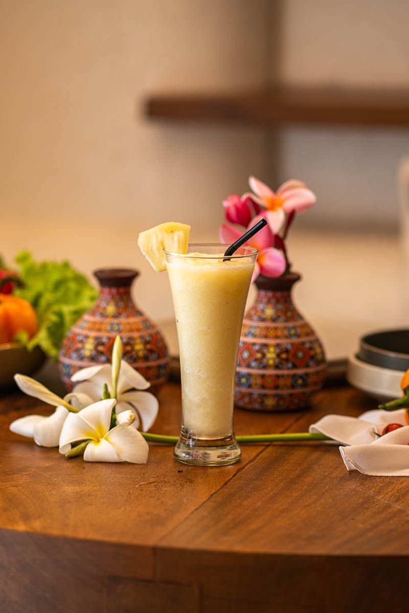 Tropical pineapple smoothie with frangipani flowers at La Cocina Costa Solana