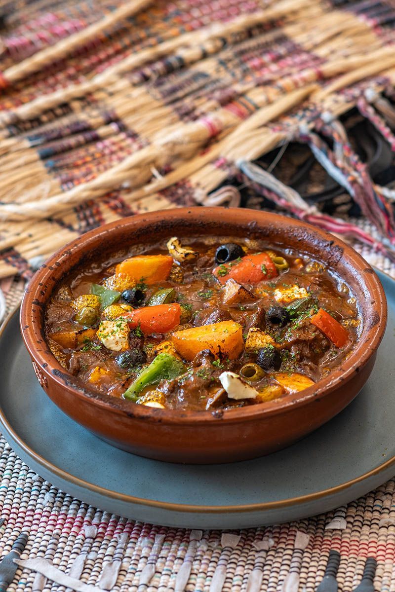 La Cocina hearty Moroccan-style beef stew served in rustic clay bowl at Costa So