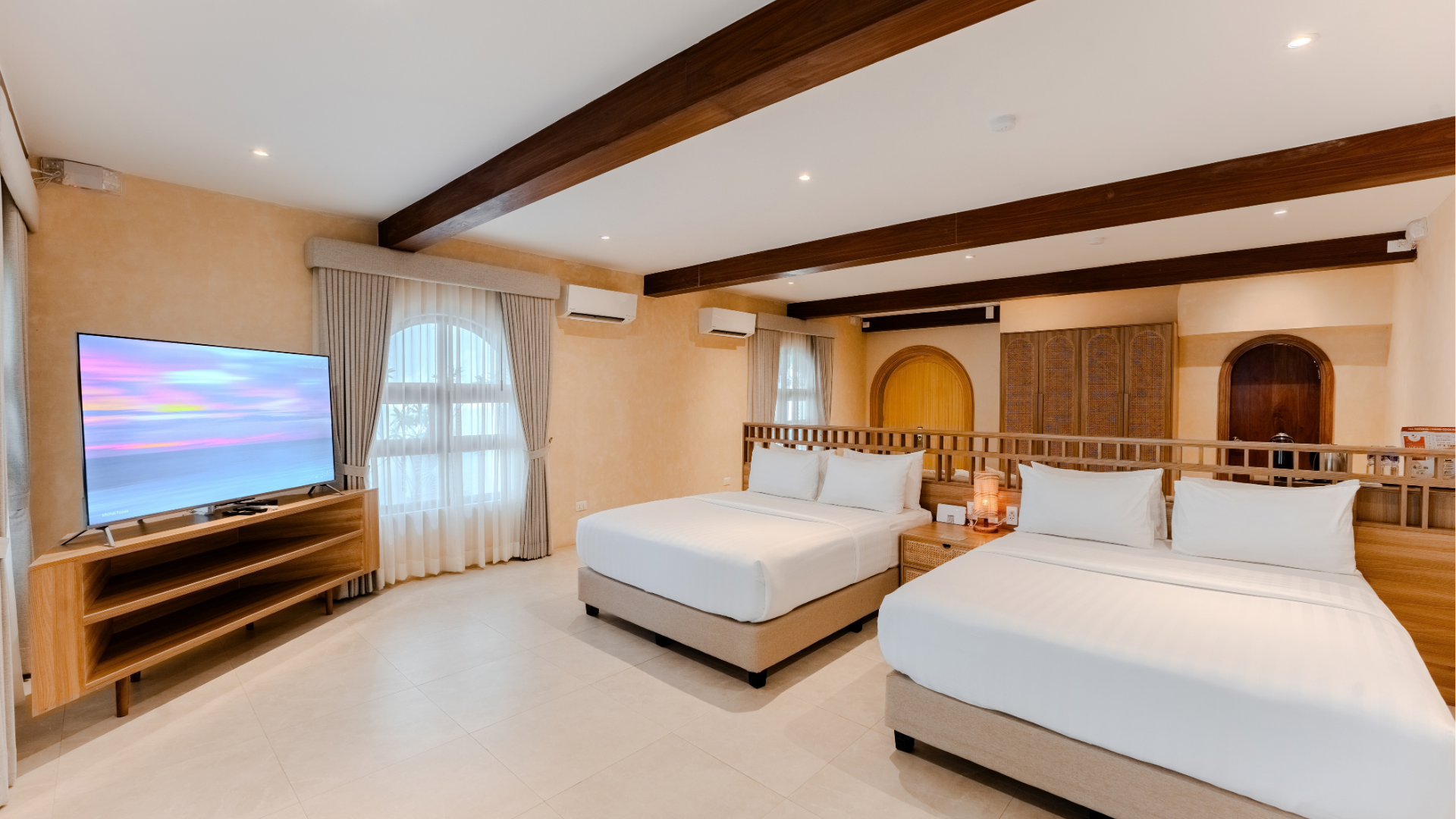 Beach Villa bedroom with wooden desk and natural light at Costa Solana Resort, Pagbilao, Quezon