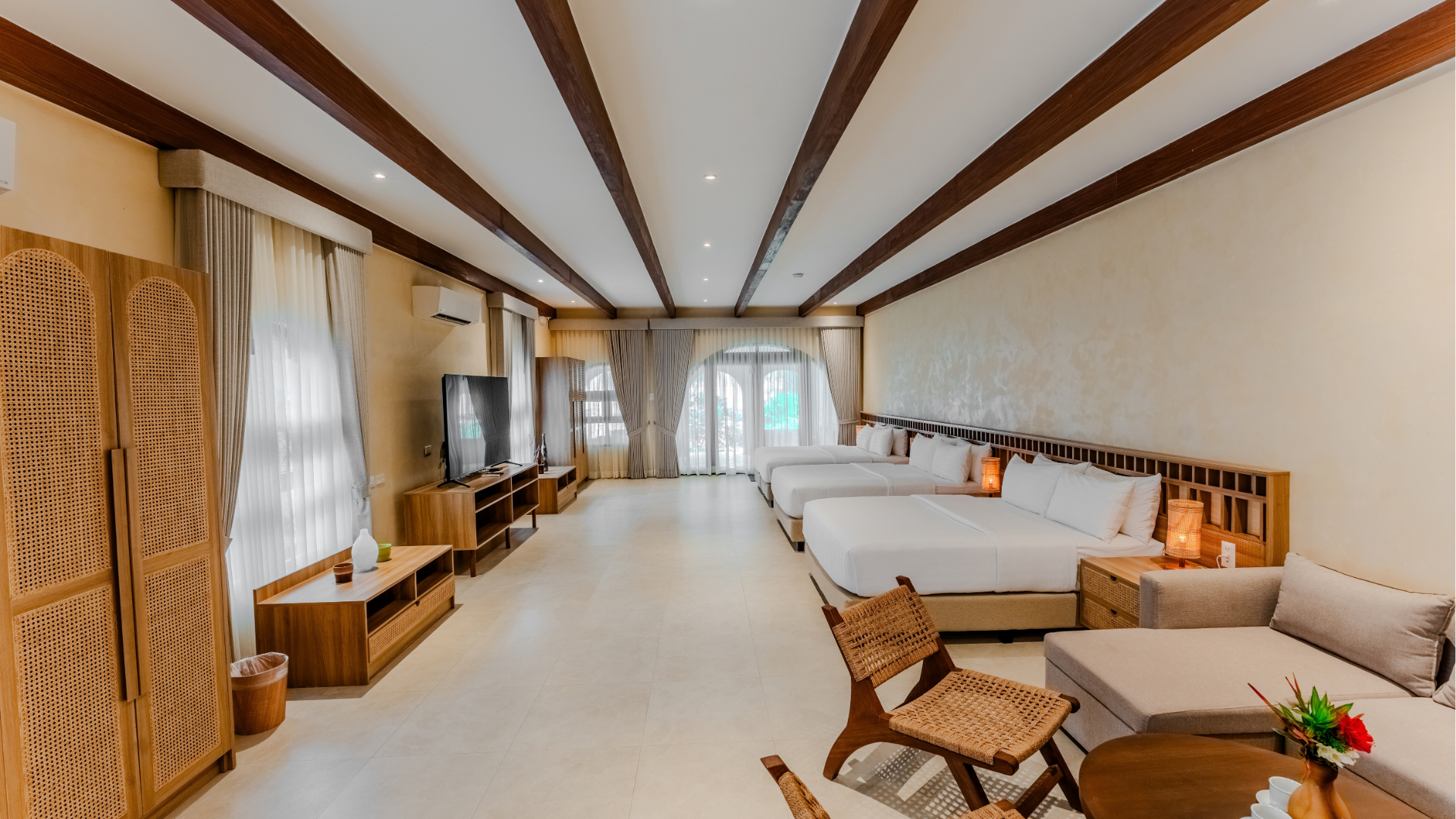Family Beach Villa bedroom with double bed and wooden accents at Costa Solana Resort, Pagbilao, Quezon