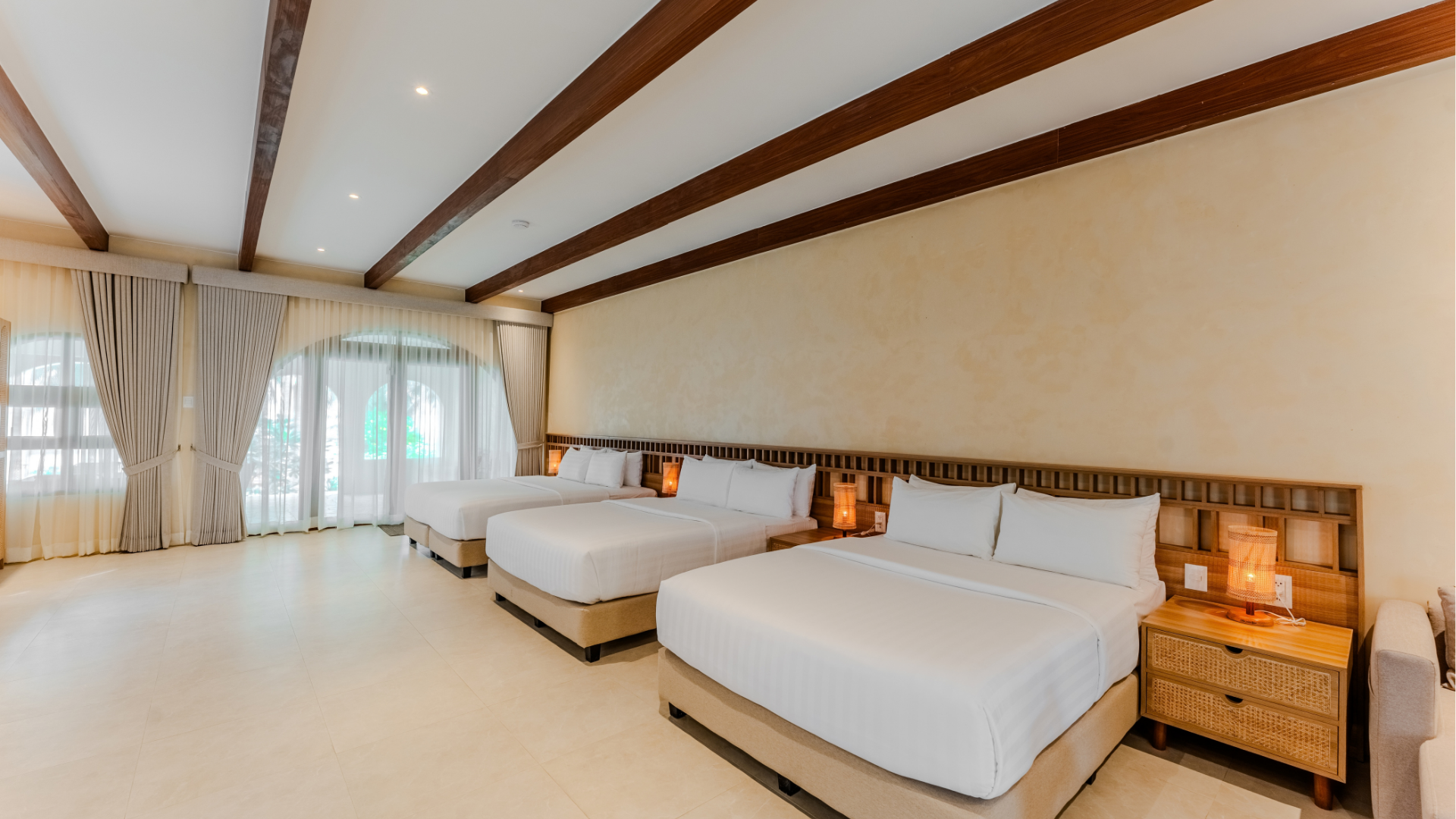 Family Beach Villa living area with wooden ceiling beams at Costa Solana Resort, Pagbilao, Quezon