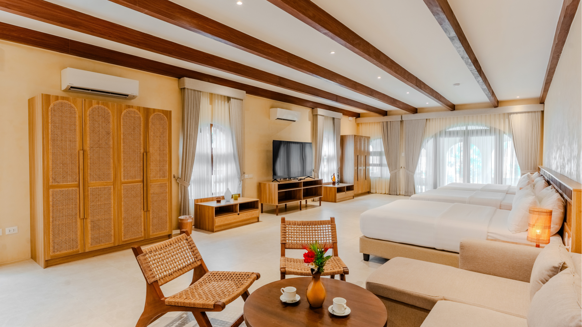 Family Beach Villa bedroom with wooden furniture and natural light at Costa Solana Resort, Pagbilao, Quezon