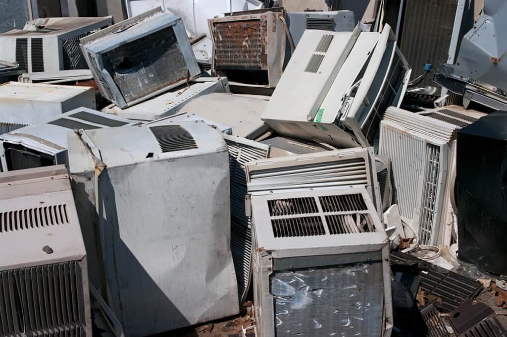 A pile of old computer monitors and air conditioners