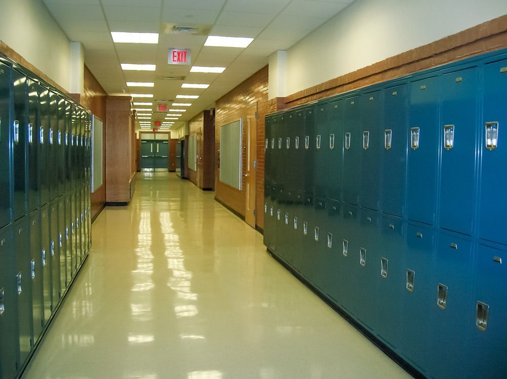 A Pennsylvania school hallway with blue lockers, shiny floor, and an 