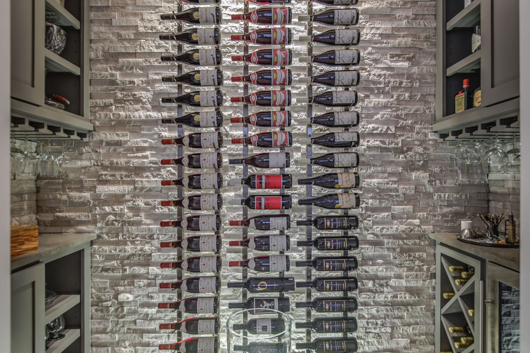 A row of wine bottles hanging on a wall in a wine cellar.