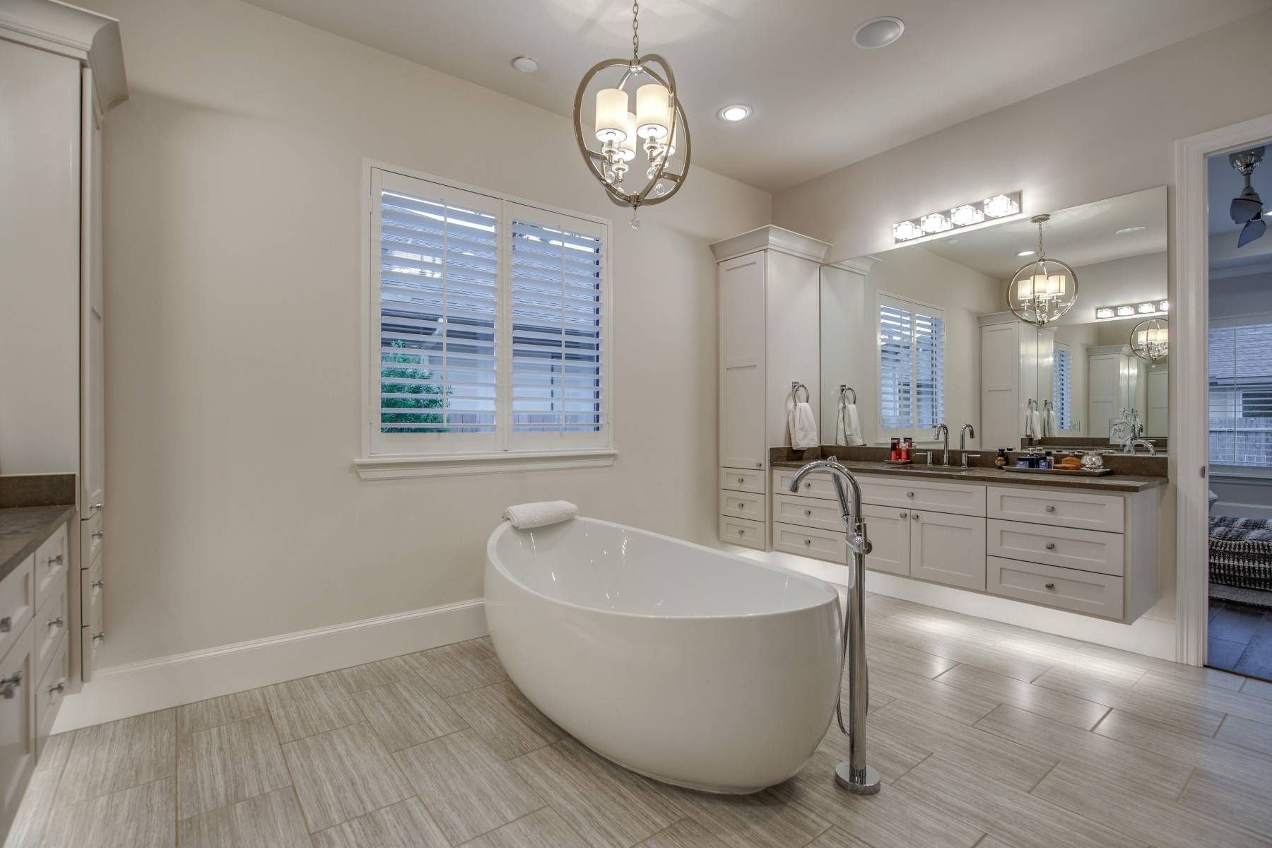 A bathroom with a bathtub and two sinks.