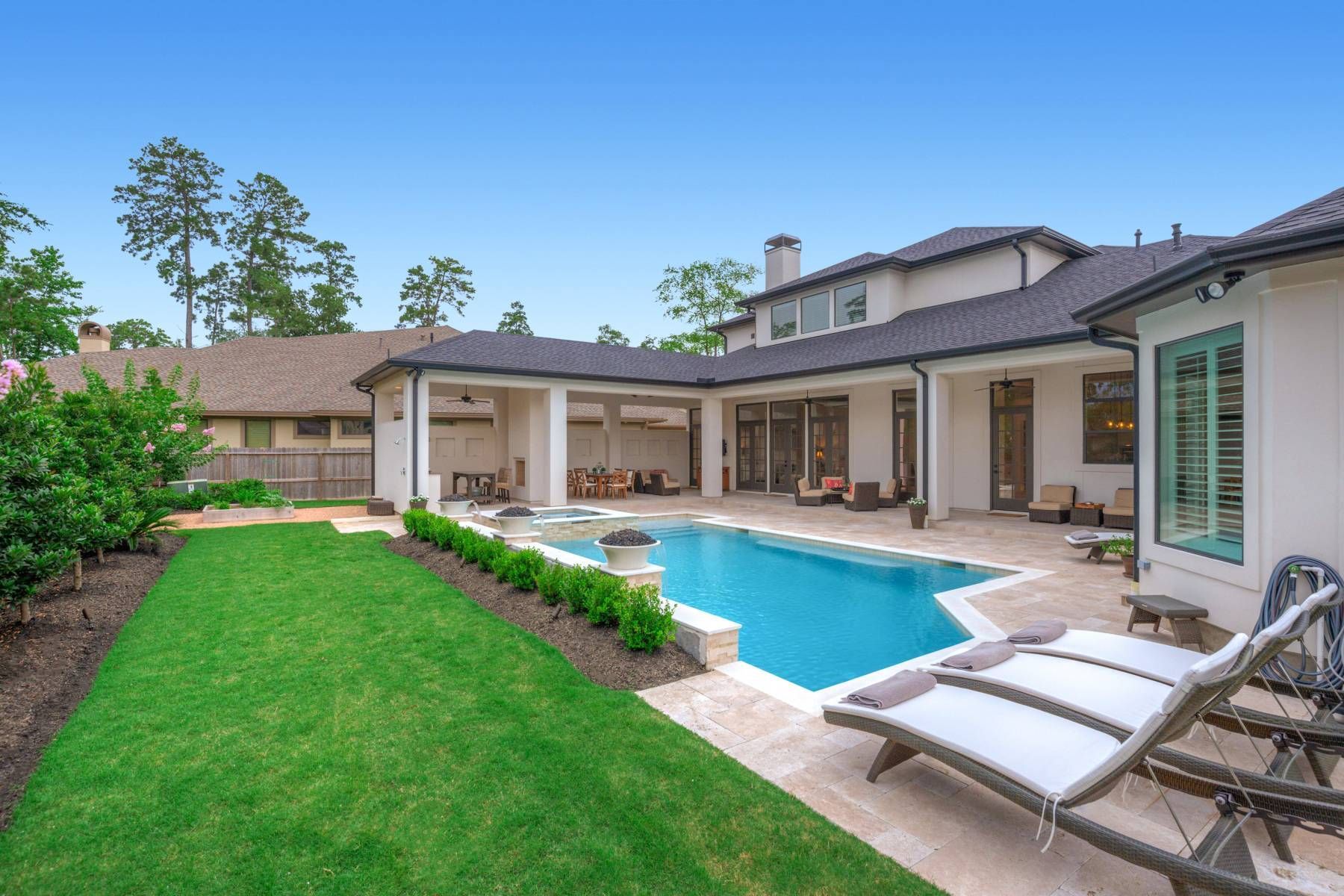 A large house with a large swimming pool in the backyard.