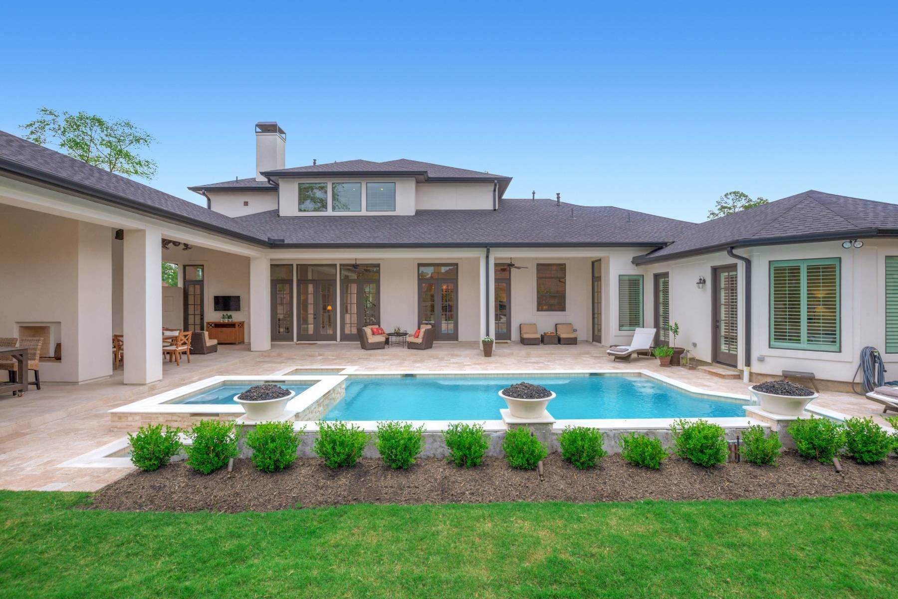A large house with a large swimming pool in the backyard.