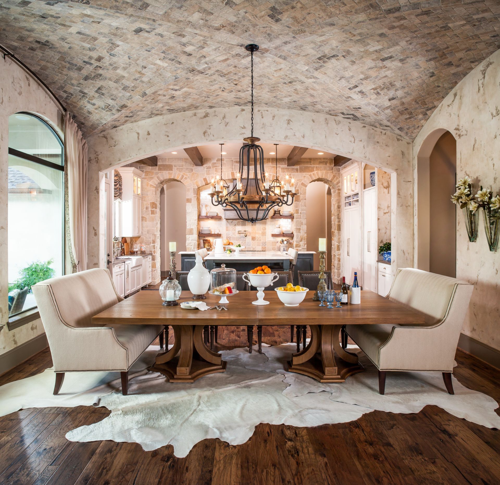 A dining room with a table and chairs and a cowhide rug