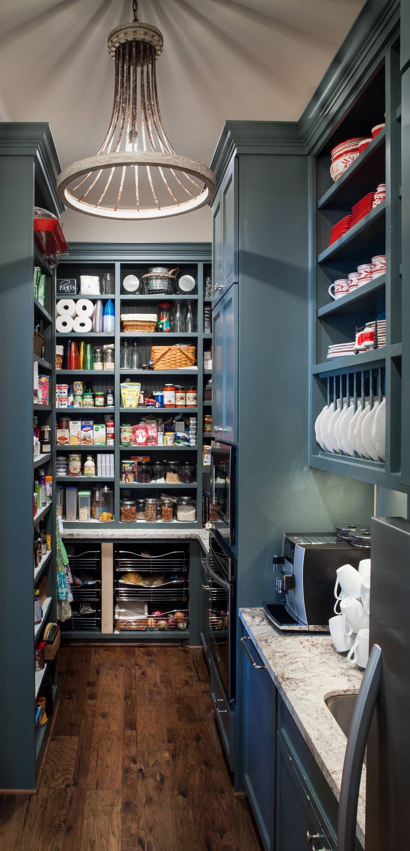 A kitchen with a pantry filled with lots of food and a refrigerator.