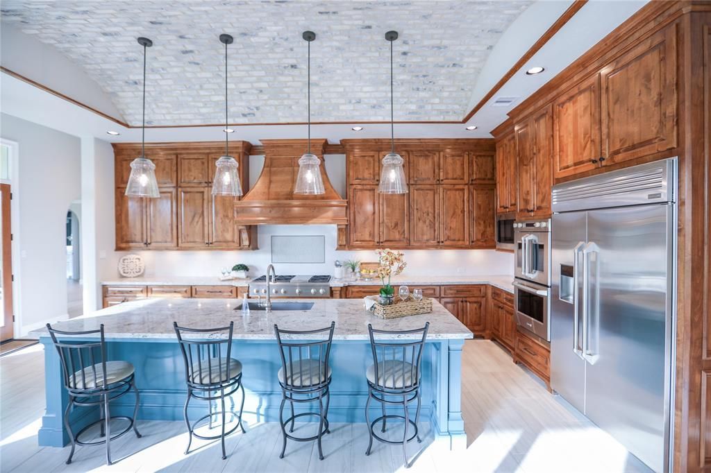 A kitchen with stainless steel appliances and wooden cabinets