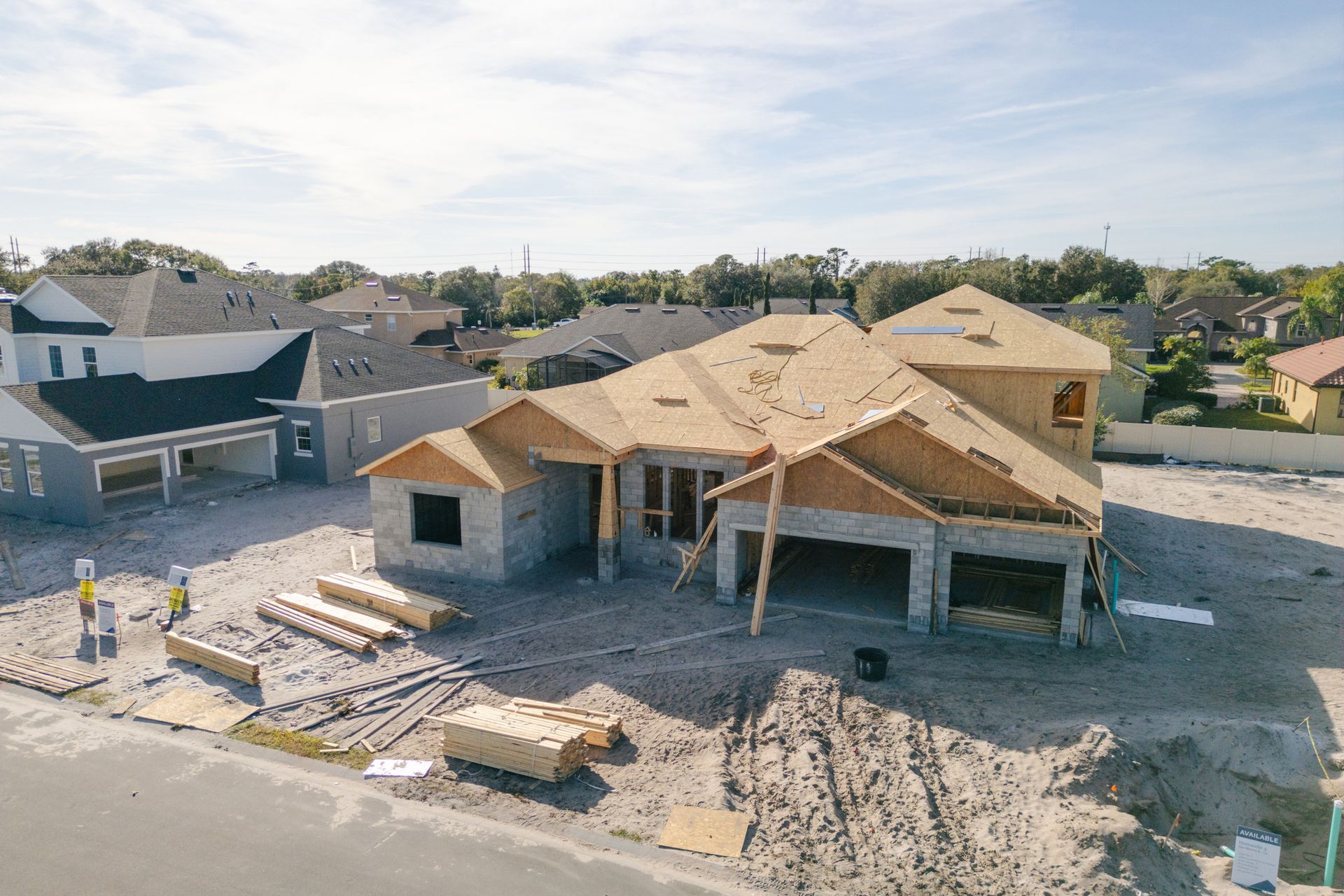 An aerial view of a house under construction in a residential area.