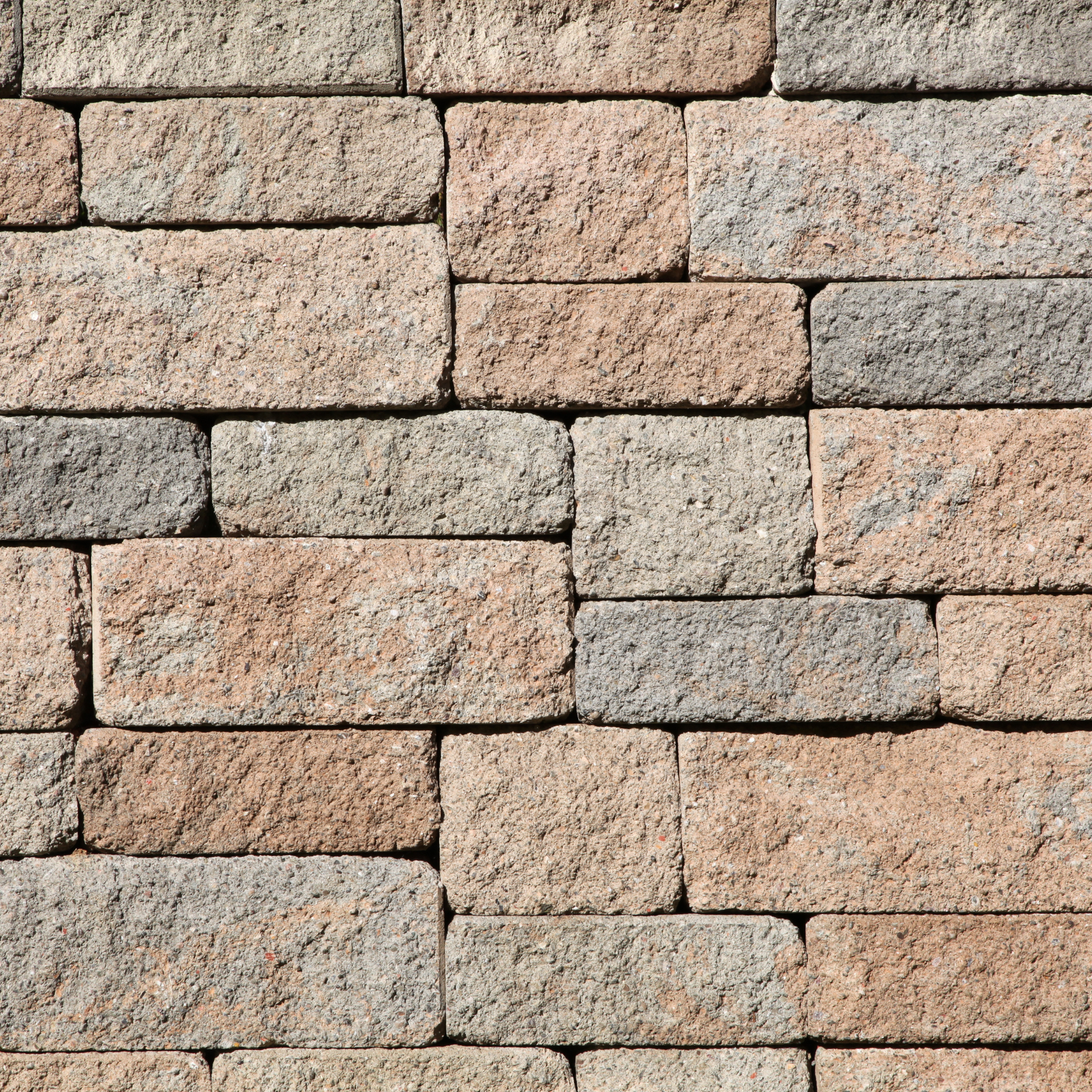 A close up of a brick wall made of different colored bricks