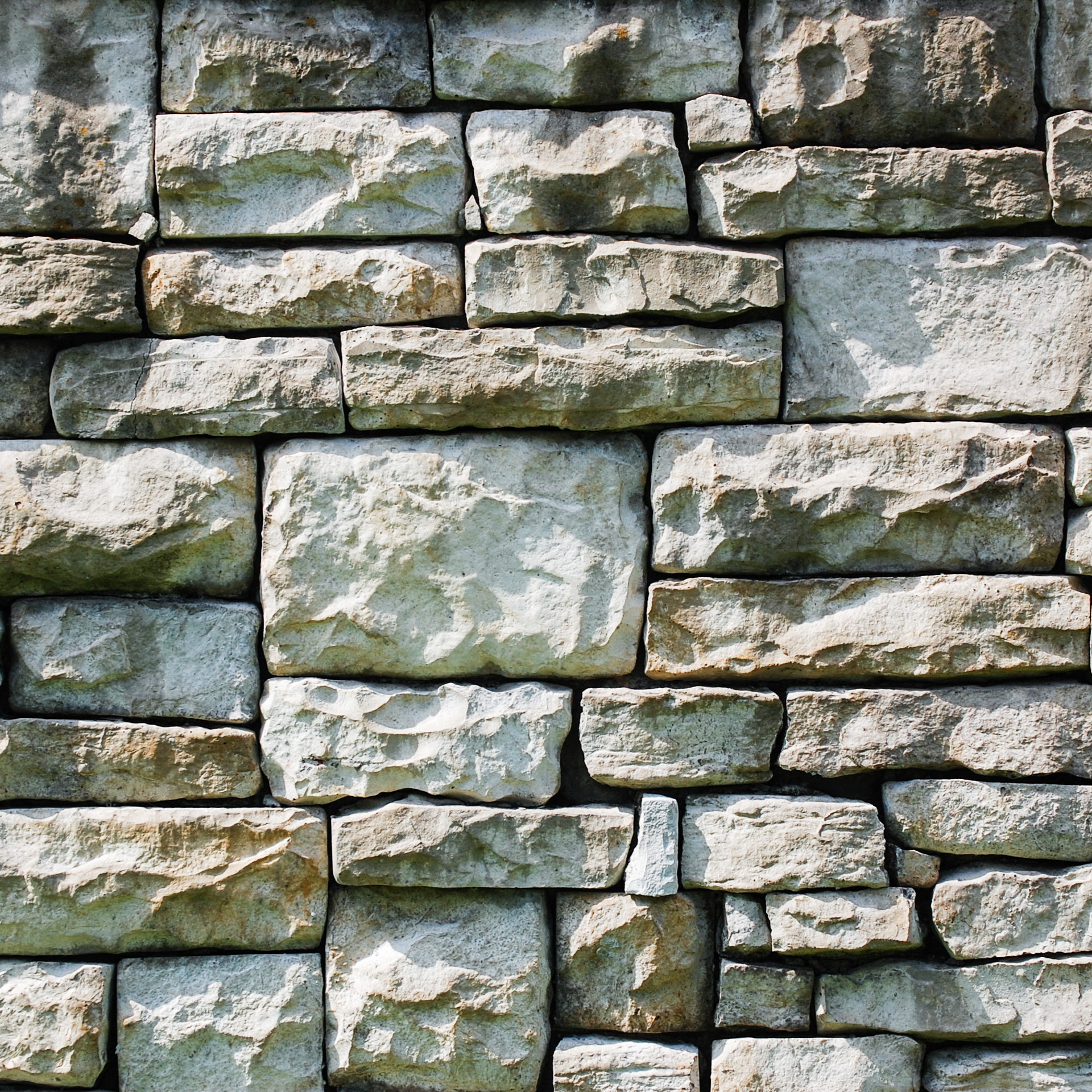 A close up of a stone wall with a lot of bricks