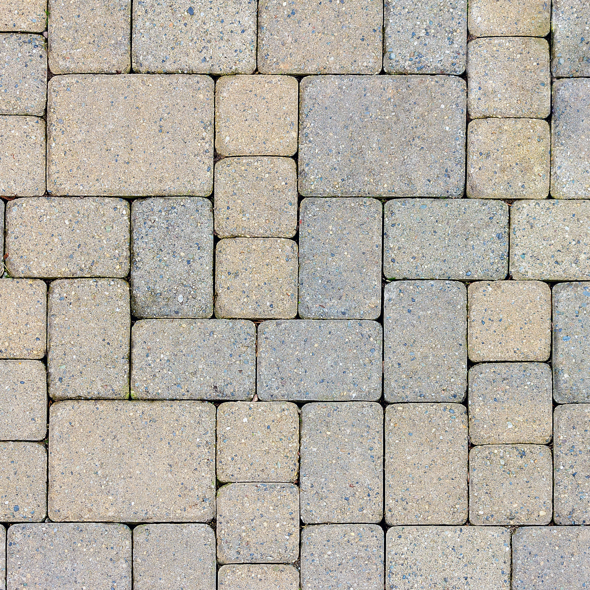 A close up of a brick pavement patio with a seamless pattern.