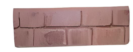 Arrangement of reddish-brown rectangular bricks with black lines.