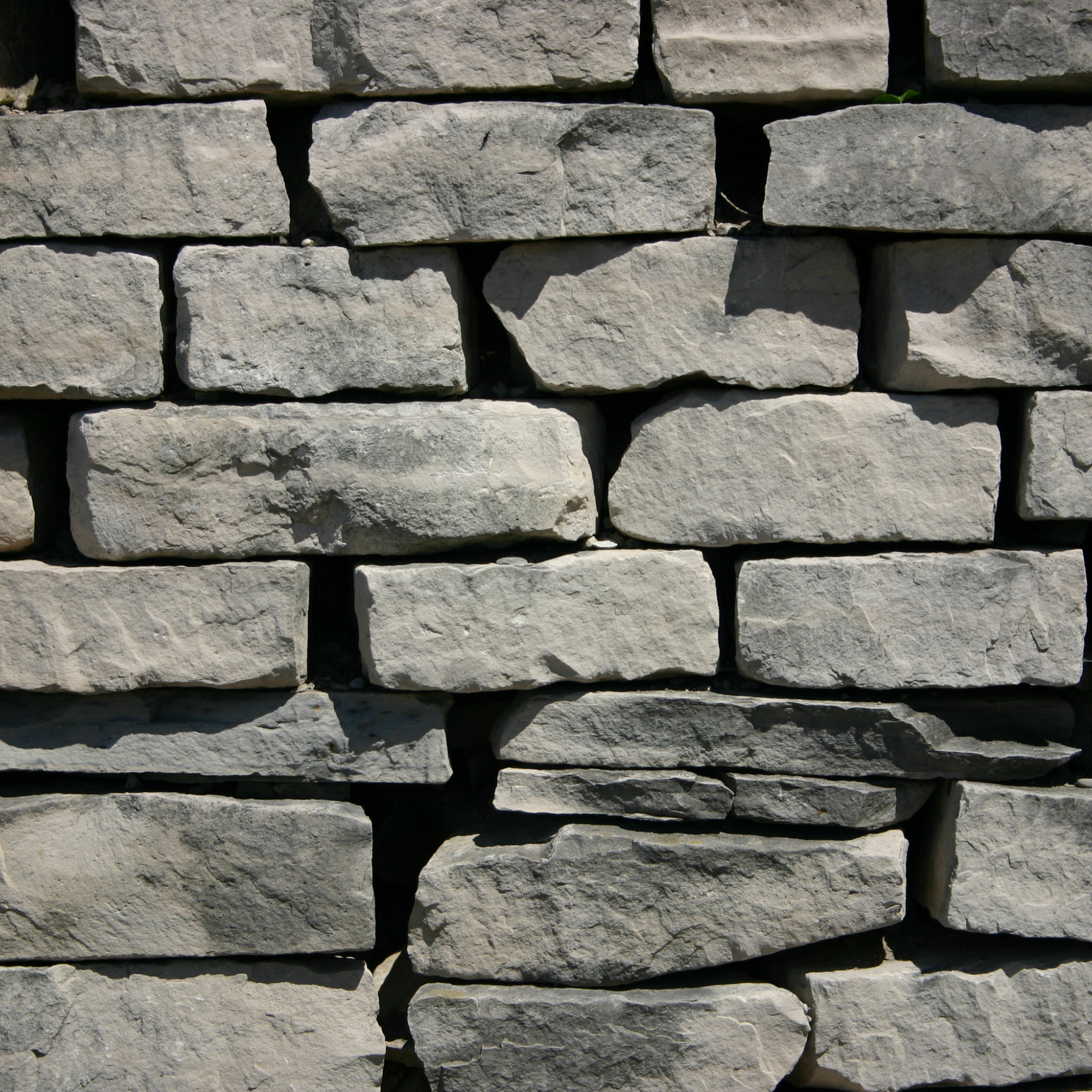 A brick wall with a lot of bricks stacked on top of each other