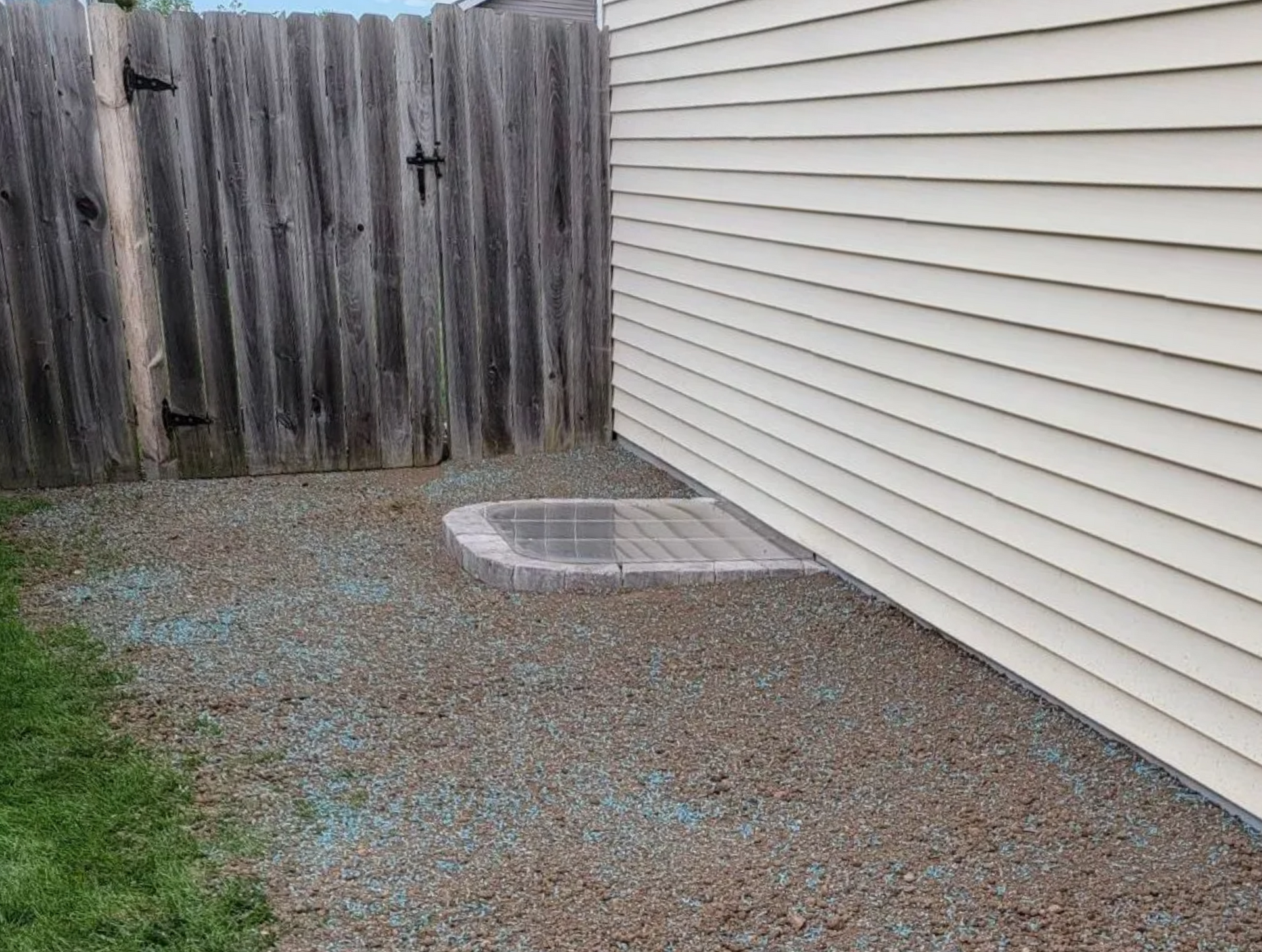 completed window well with grading and grass seed