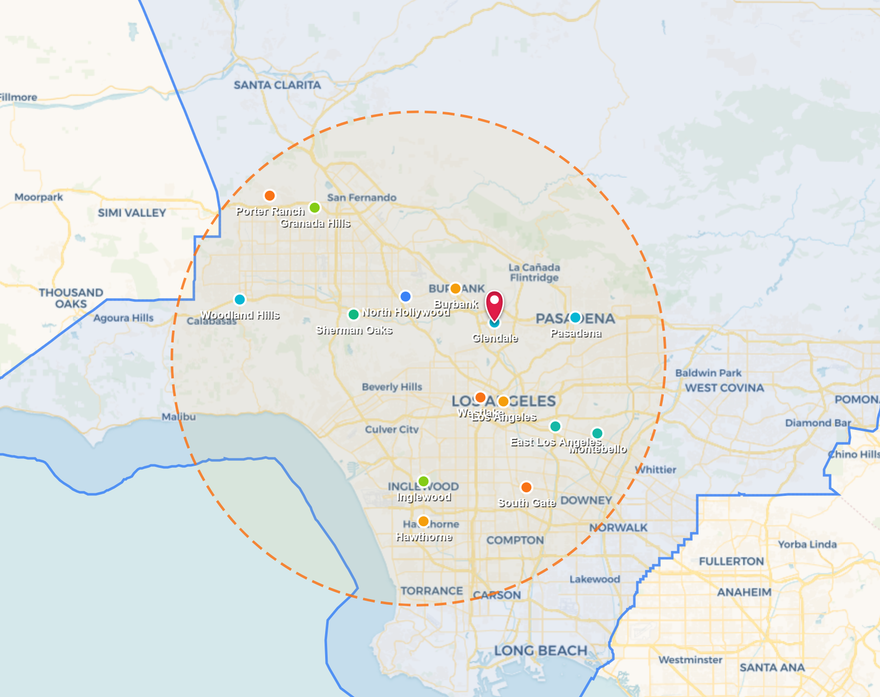 Map with green and blue outlined regions, a red location pin, and a dashed orange radius circle.
