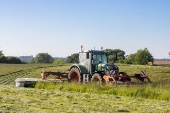 Tractor mowing a large acreage lot near Houston, TX