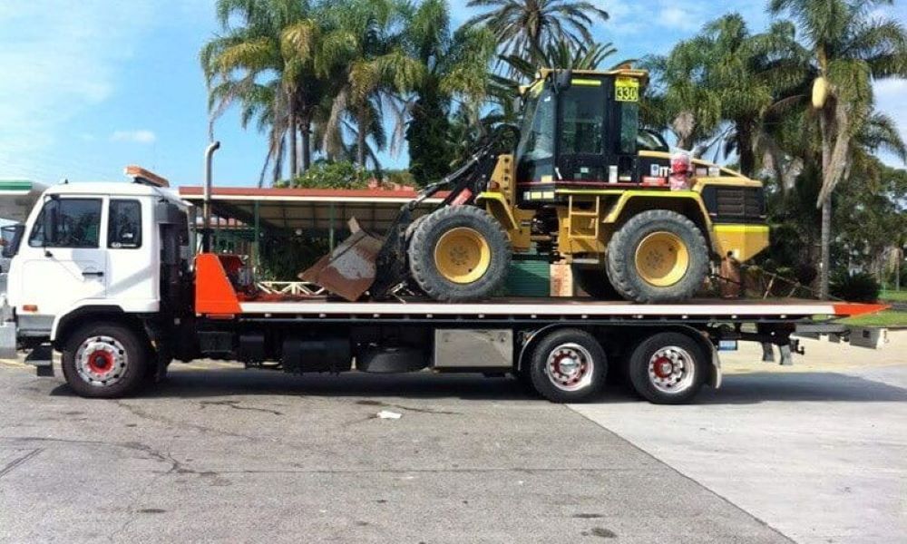 A Tow Truck with A Bulldozer on The Back of It — Easylift Towing NSW Pty Ltd In Swansea, QLD