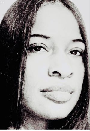 A person with dark hair and dark eyes.  Black and white picture.