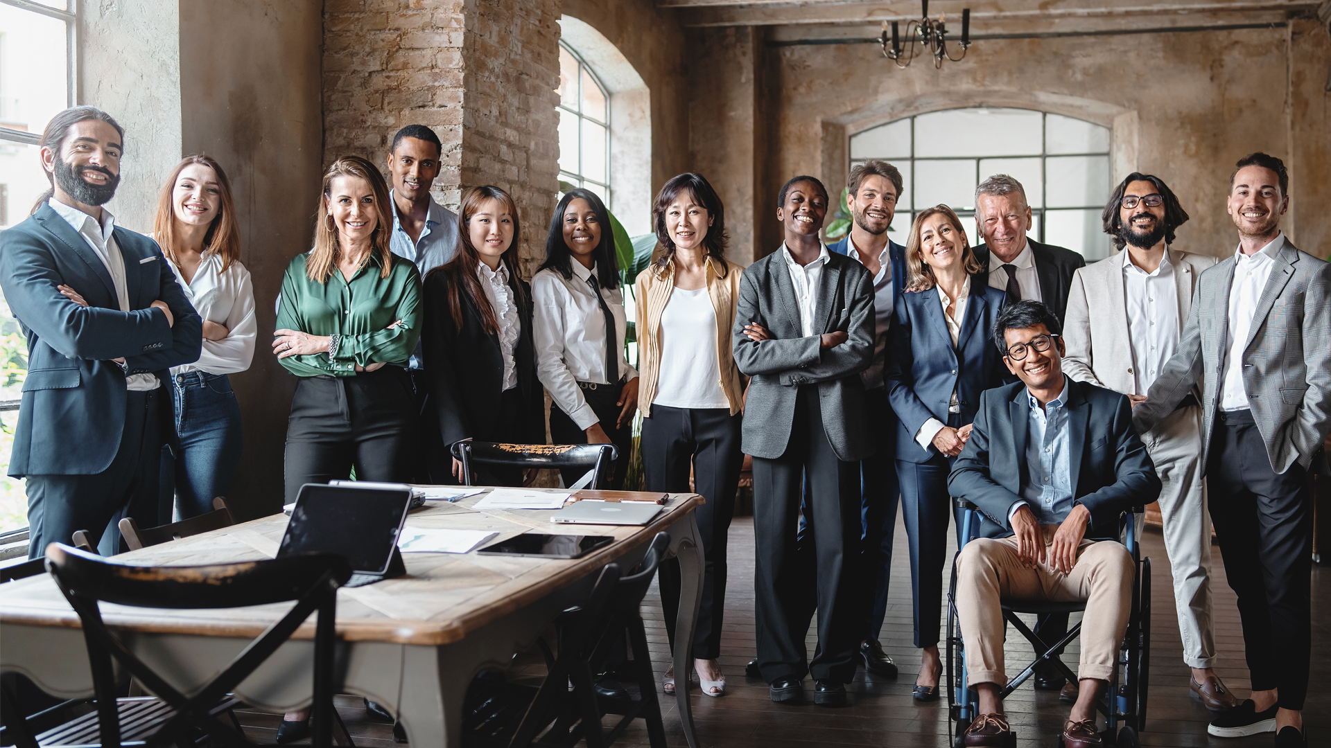 A group of business people are posing for a picture in an office.