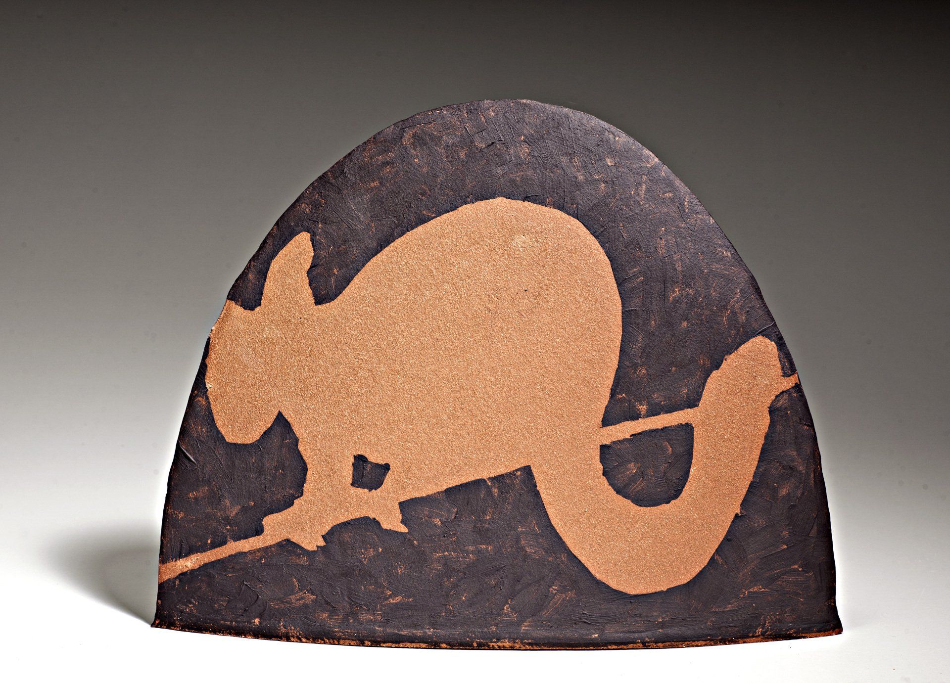 A piece of wood with a squirrel on it