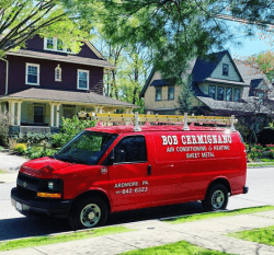 A red bob cemignano van is parked in front of a house