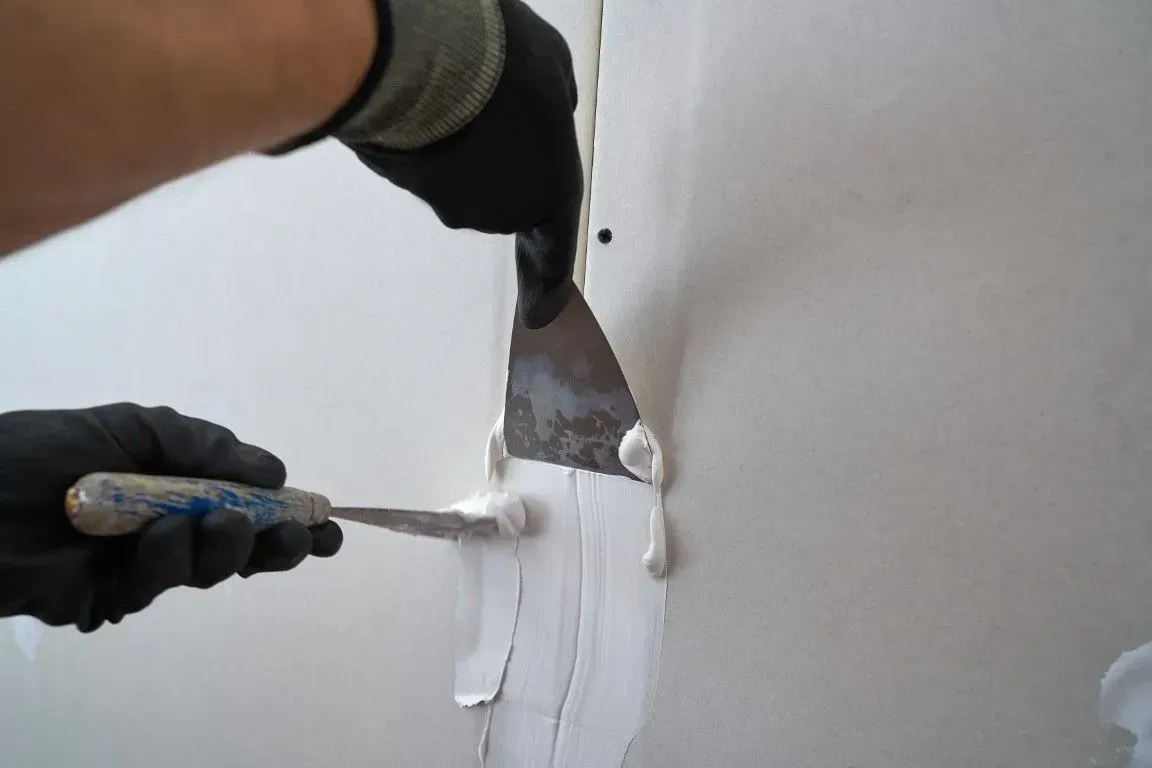 Professional patching and repairing damaged drywall panel