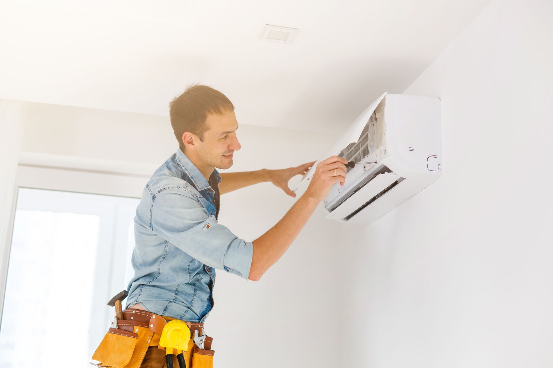 Man repairing air conditioner.