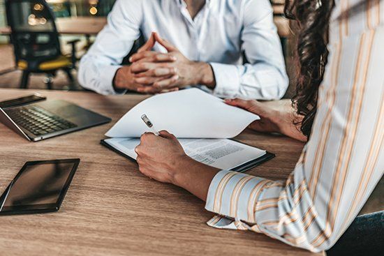 Business People Negotiating a Contract — Lincoln, NE — Advantage Insurance Agency Business People Negotiating a Contract — Lincoln, NE — Advantage Insurance Agency