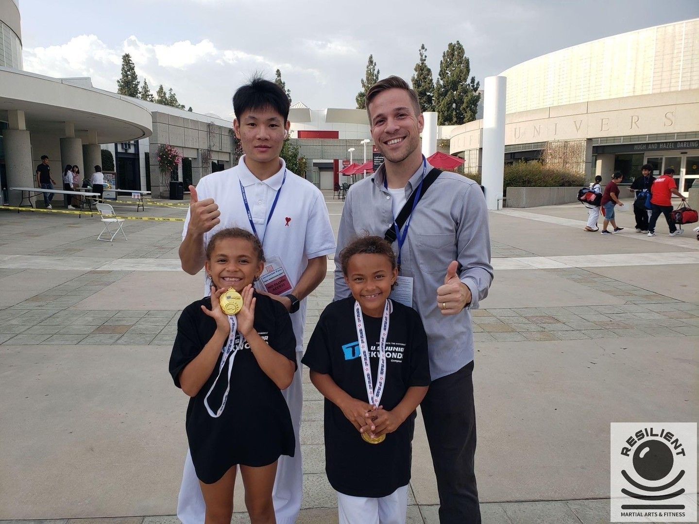A group of people posing for a picture with medals around their necks
