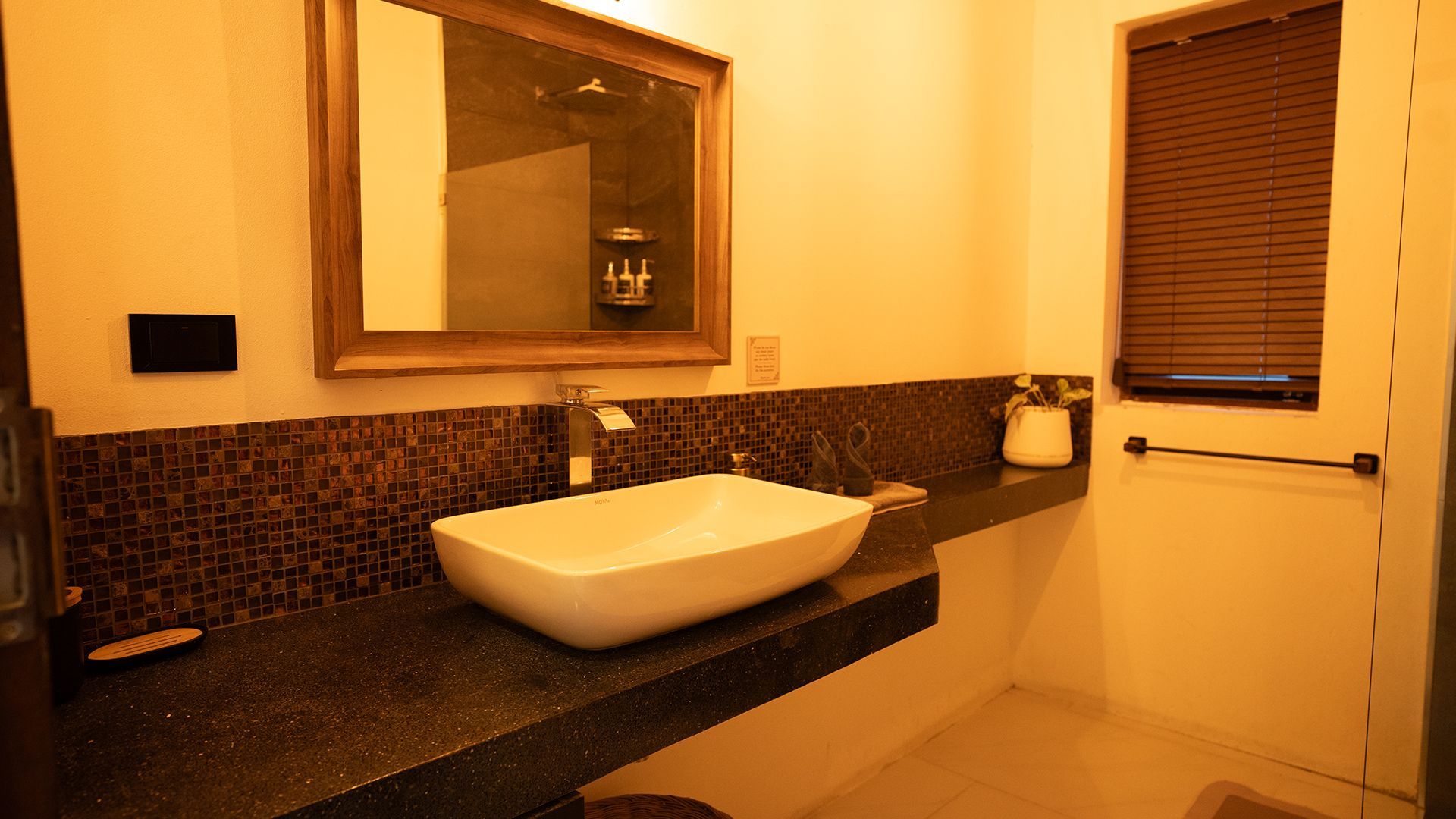 Modern bathroom with vessel sink, mirror, and warm beige walls