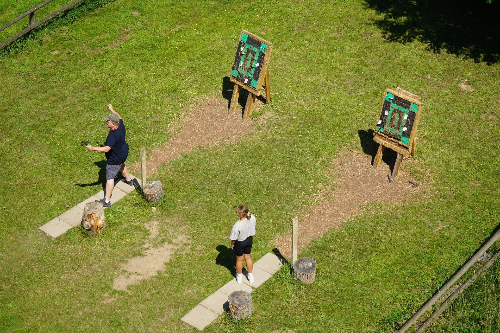 People playing a game with targets set up on an open grassy area.
