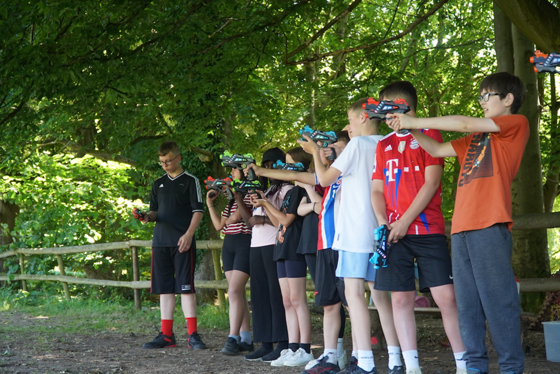 A group of children playing laser tag in the woods on a School Trip  outdoor activity centres