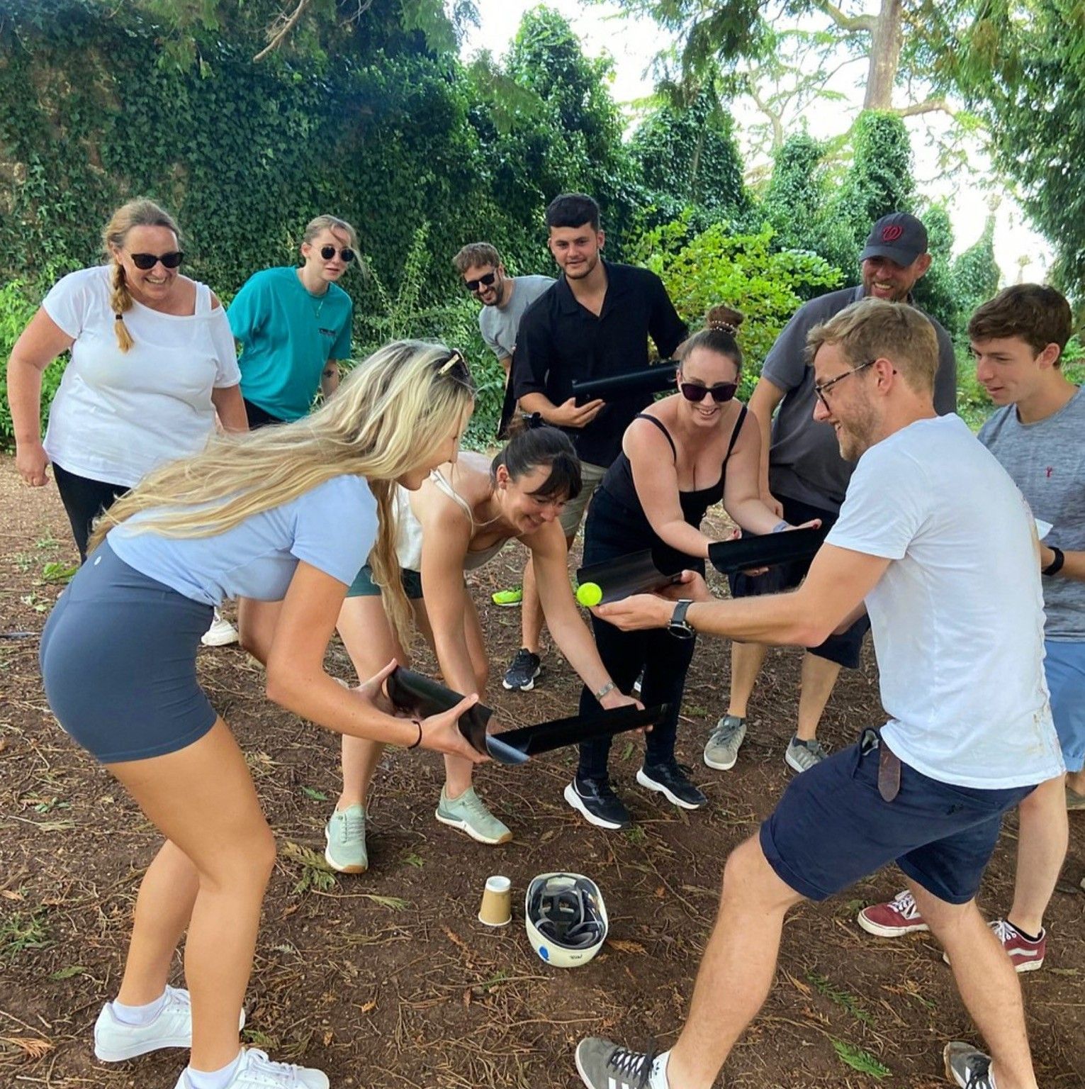 Group of people playing a game with tennis balls and tubes. adventure activities