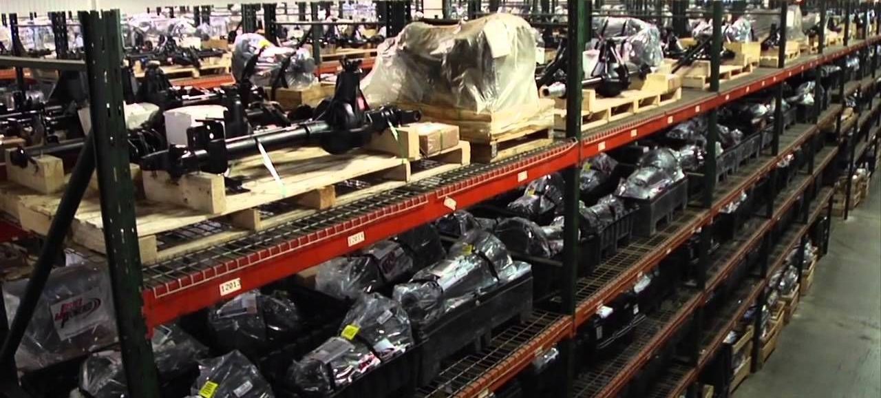 Warehouse with shelves stacked with packaged car parts.