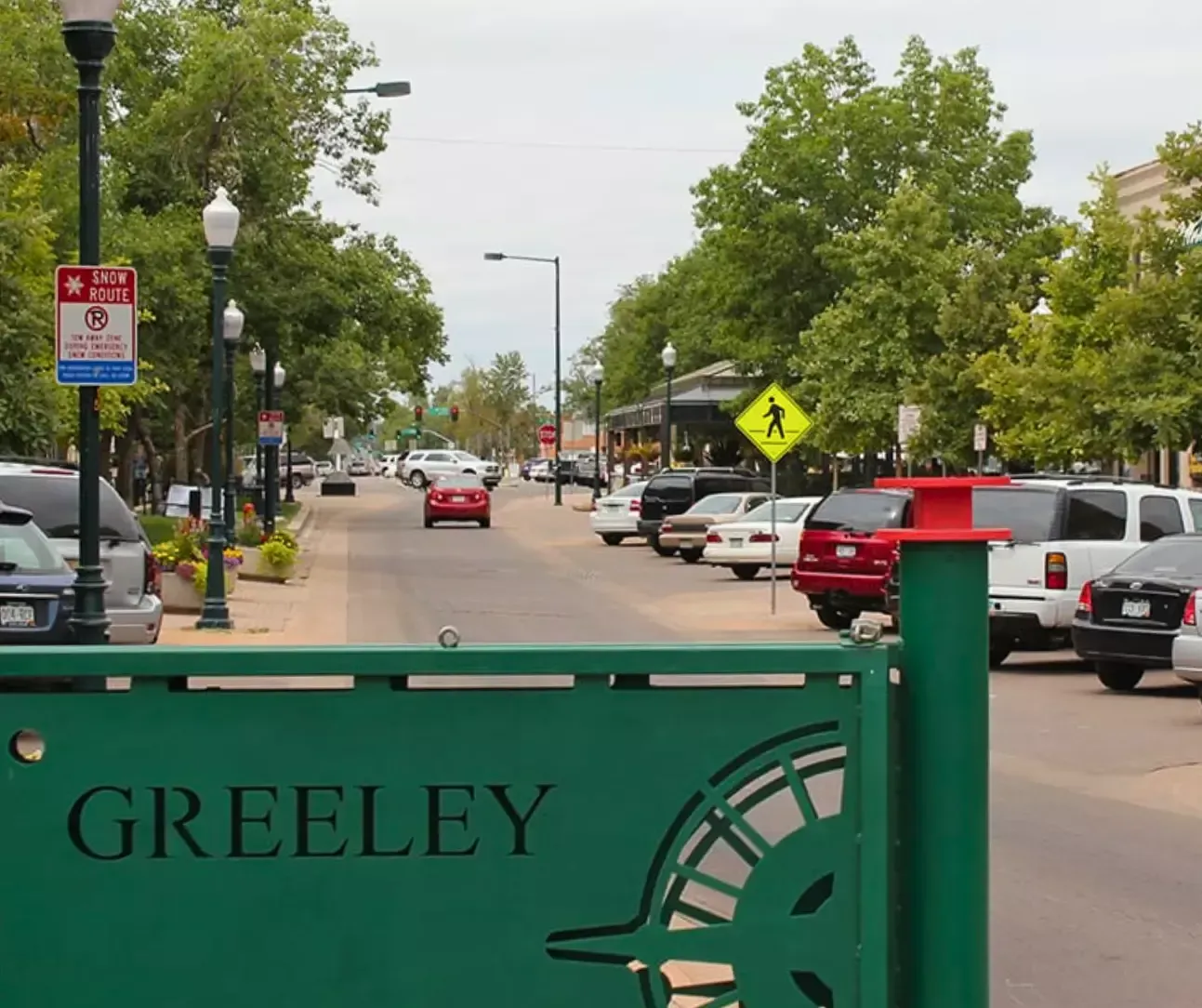 Street scene with Greeley sign and neighborhood shops in Greeley, Colorado