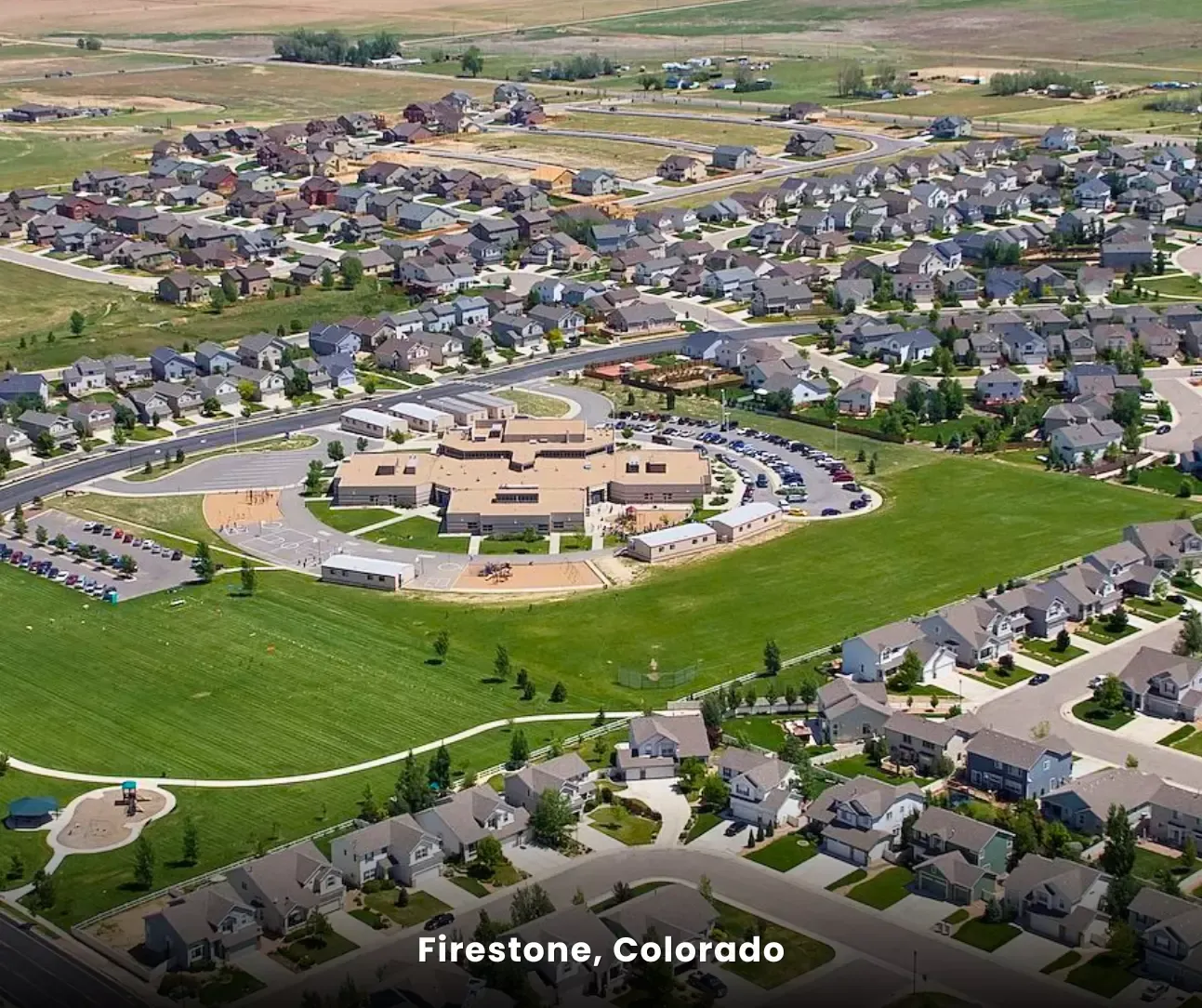 Firestone, Colorado aerial view of residential neighborhood and school, service area for expert carpet cleaning services